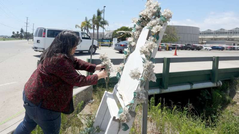 A woman pays her respects to Jaime Alanís García, the farmworker who died from injuries during the July 2025 Glass House immigration raid.