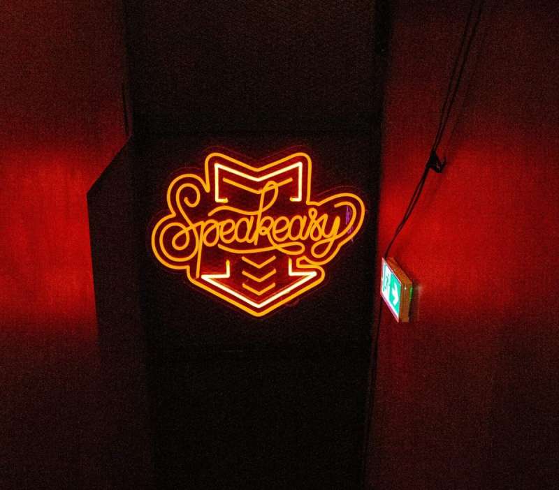 You just have to know where to look to find the best speakeasies in San Diego, one hint would be this bright neon sign that reads "Speakeasy"