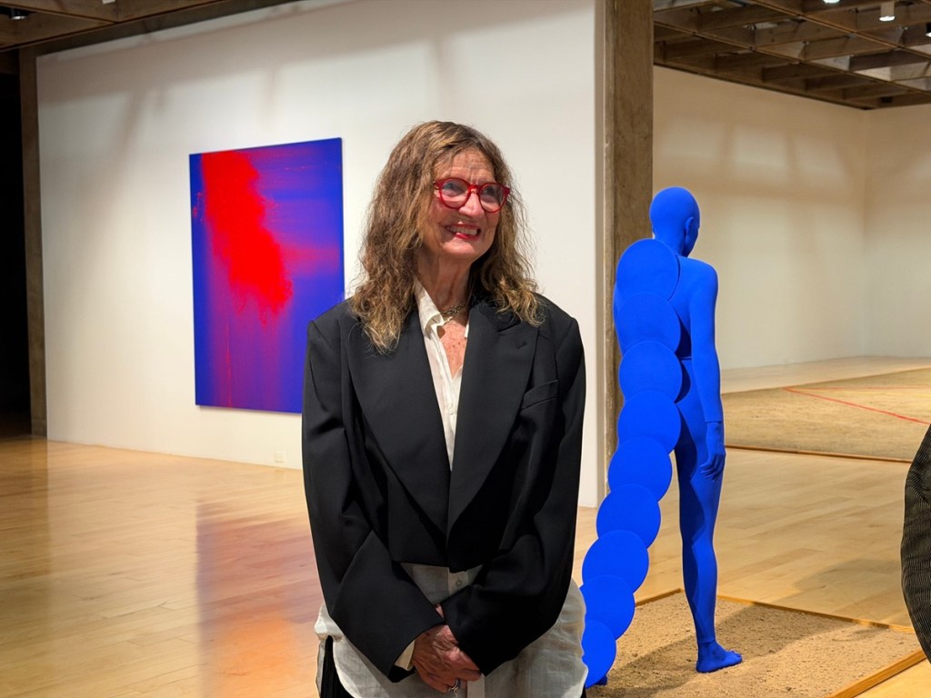 A woman stands inside her exhibit at the Palm Springs Art Museum